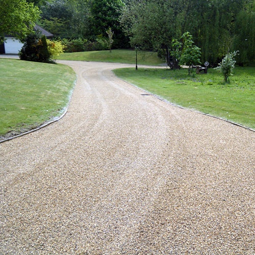 photo of long chip and tar driveway